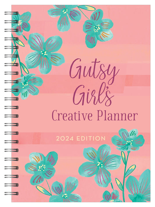 Pink spiral bound bookcover with green flowers. "Gutsy Girl's Creative Planner 2024 Edition"