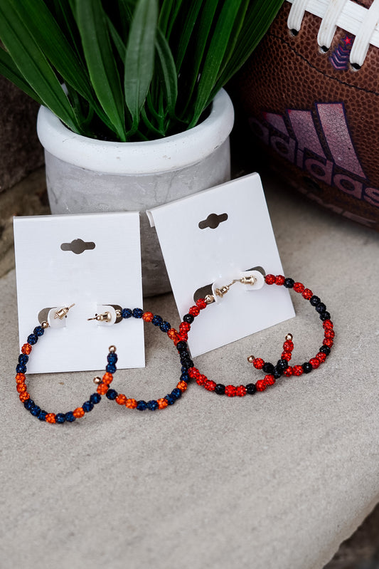 Are you a school pride lady, but can't give up your statement hoops? No fear!! The School Pride Beaded Hoop Earrings will compliment those Friday Night Lights outfits perfectly!! School Pride Beaded Hoop Earrings Red/Black and Navy/Blue Stud Post Back. Red and black beads on earrings. Navy and orange beads on earrings.