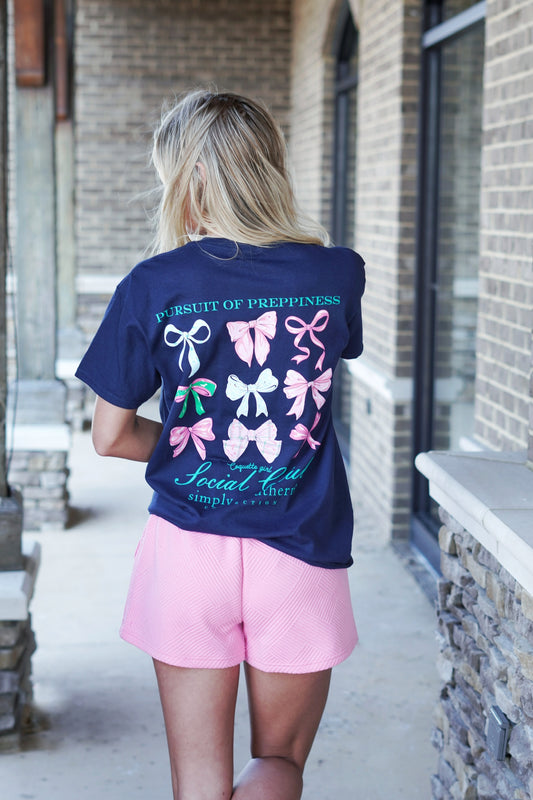 <ul> <li>Simply Southern Hair Tie T-Shirt</li> <li>Crew Neckline</li> <li>Short Sleeve</li> <li>Full Length</li> <li><span>Navy blue short sleeve shirt with the phrases 'Pursuit of Preppiness', Coquette Girl', and 'Social Club'. There are a variety of hair ties and bows. Simply Southern logo below and on left chest</span></li> <li>Color: Navy</li> <li>100% Cotton</li> </ul>