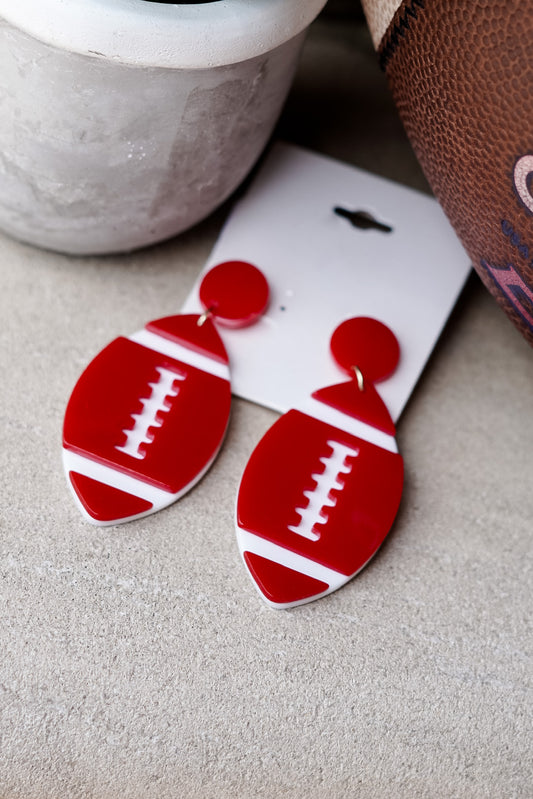 You love to let people know who you root for when football season is here. Whether you are a Jax State Gamecock, an Albertville Aggie, or any football fan who loves to accessorize, the Bobby Football Earrings will pair with your casual or dressy game day 'fit!! Bobby Football Earrings Stud Post Back. Red and white football earrings.