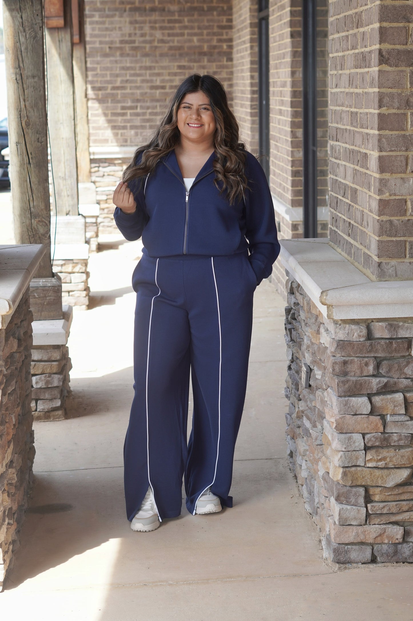 Spanx Air Essentials Track Pant in Navy, White Vertical Stripe Down Middle, Slits by the Ankle, Pocket on Both Sides