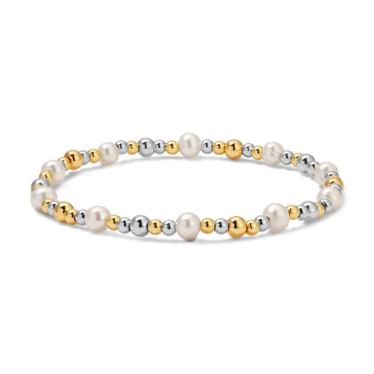 Bracelet with pearls, sliver and gold beads on a white background