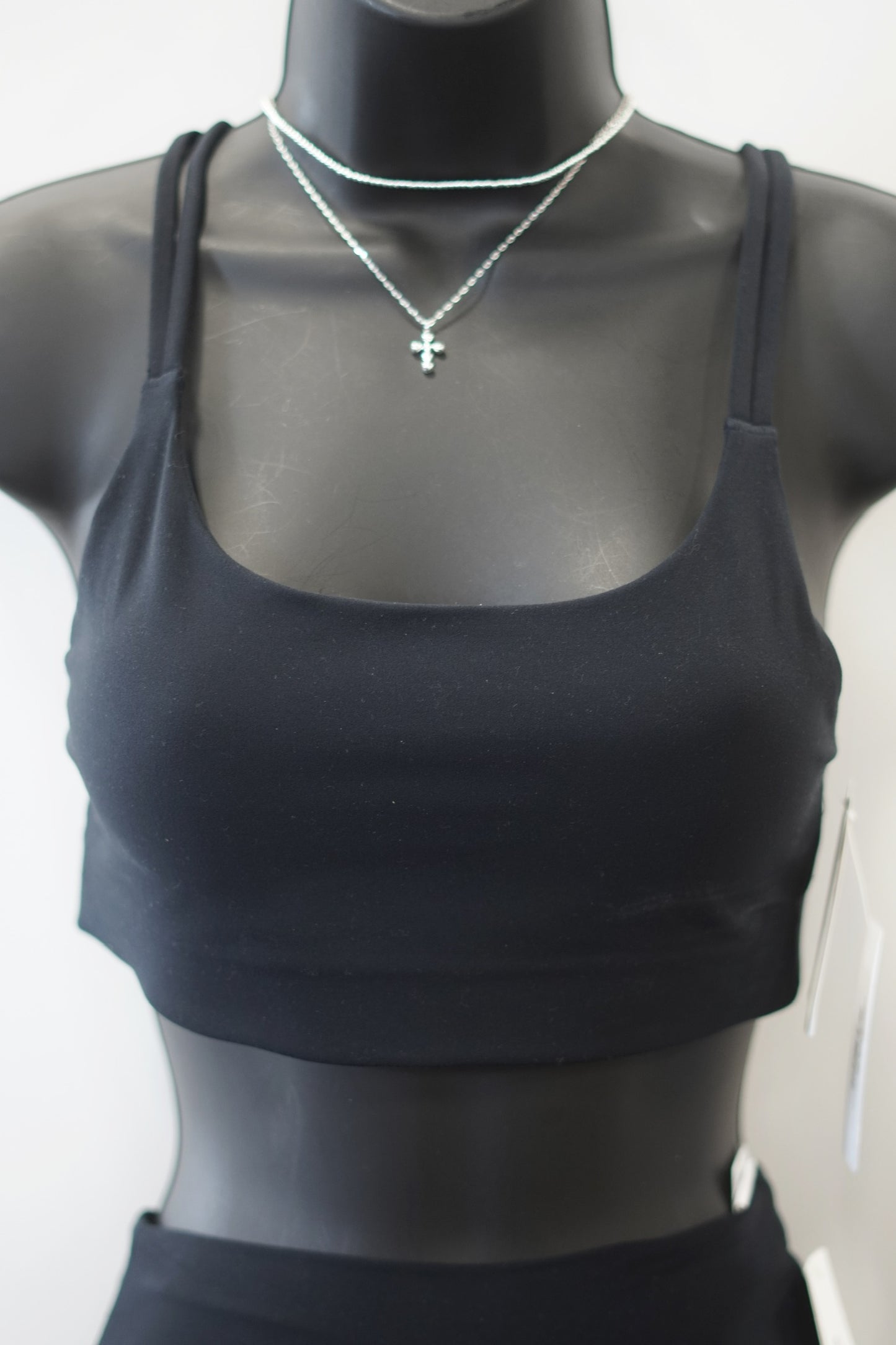 very black colored sport bra, scoop neckline, dig-free straps.