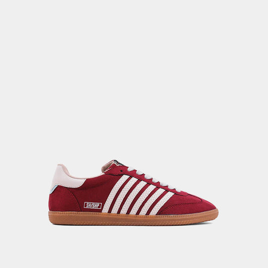 STEVIE in Wine Suede. Crafted in rich faux suede with white stitched stripes, a contrasting heel tab, and a lightweight gum sole.
