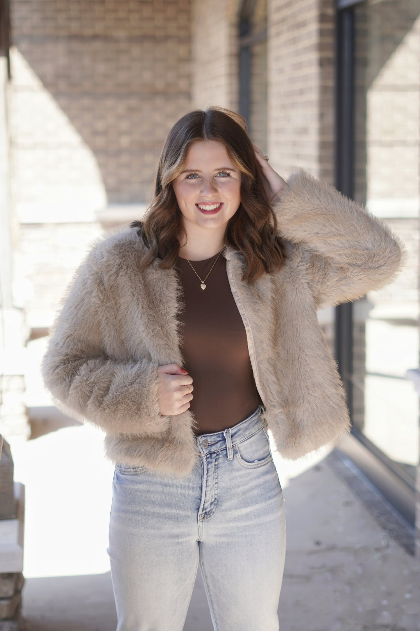 Elevate your style with this elegant dressy fur jacket, designed for those special occasions. Crafted from sumptuous faux fur, it features a tailored silhouette that flatters any figure. The luxurious texture adds a touch of sophistication, while subtle embellishments. Perfect for layering over evening wear, this jacket ensures you stay warm without compromising on elegance. Brown