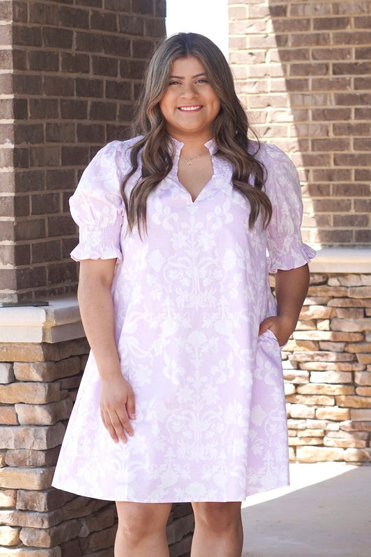 Lavender and white floral print dress. V-neckline. Above the knee. Elastic short sleeves