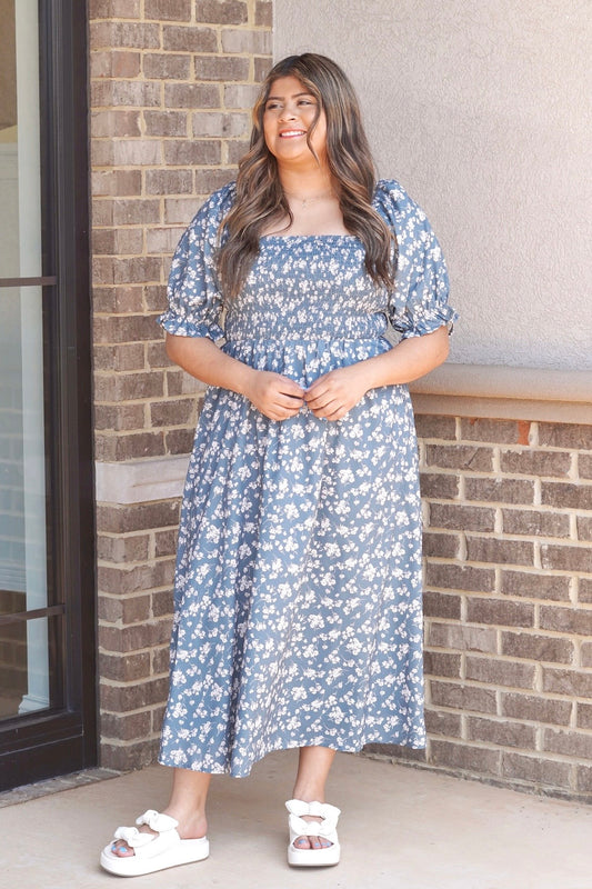 Square neckline. Puff short sleeves. Green with white floral print. Midi dress.