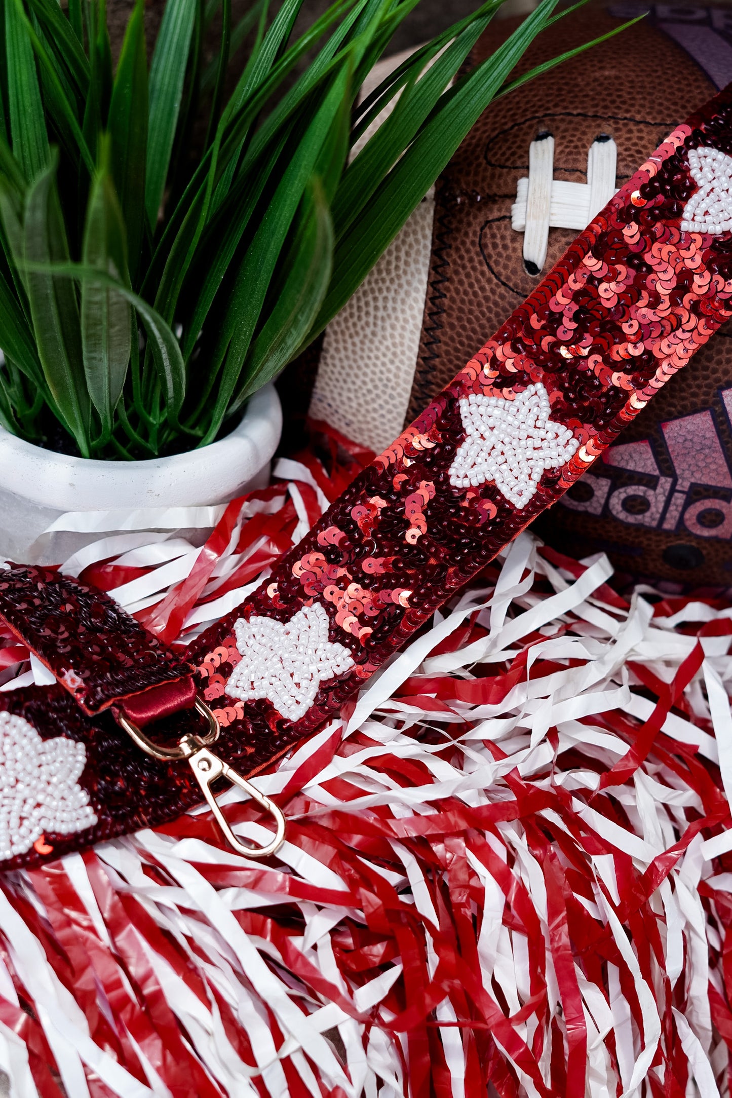 Clear bags can be such a bore when your outfit is on point for game day!! No fear, grab a Game Day Beaded Crossbody Strap whether you are Rolling with the Tide or headed to the Plains!! Sequin Game Day Strap 46.5" including gold hooks. Crimson sequin strap with white beaded stars.