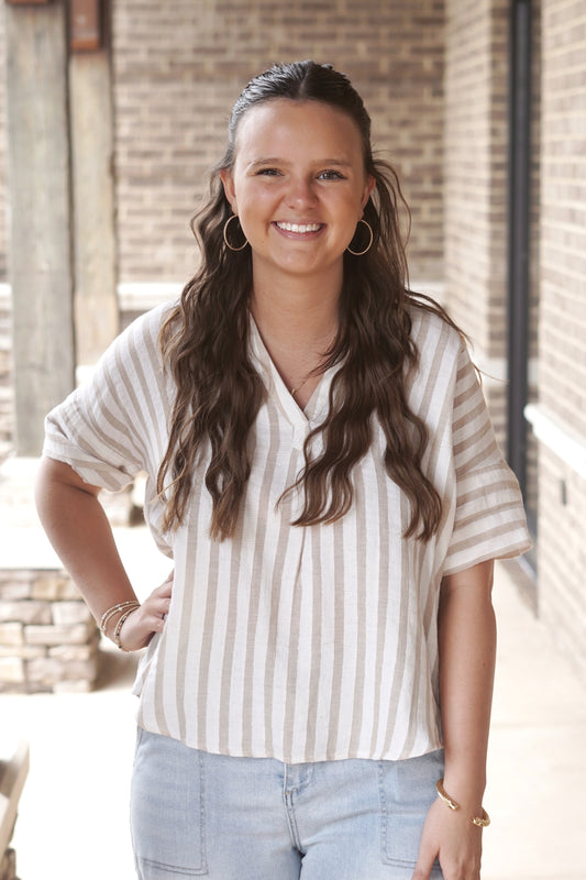 Cream and tan striped top. Stripes are horizontal. V neckline. Short sleeve. Full length top.