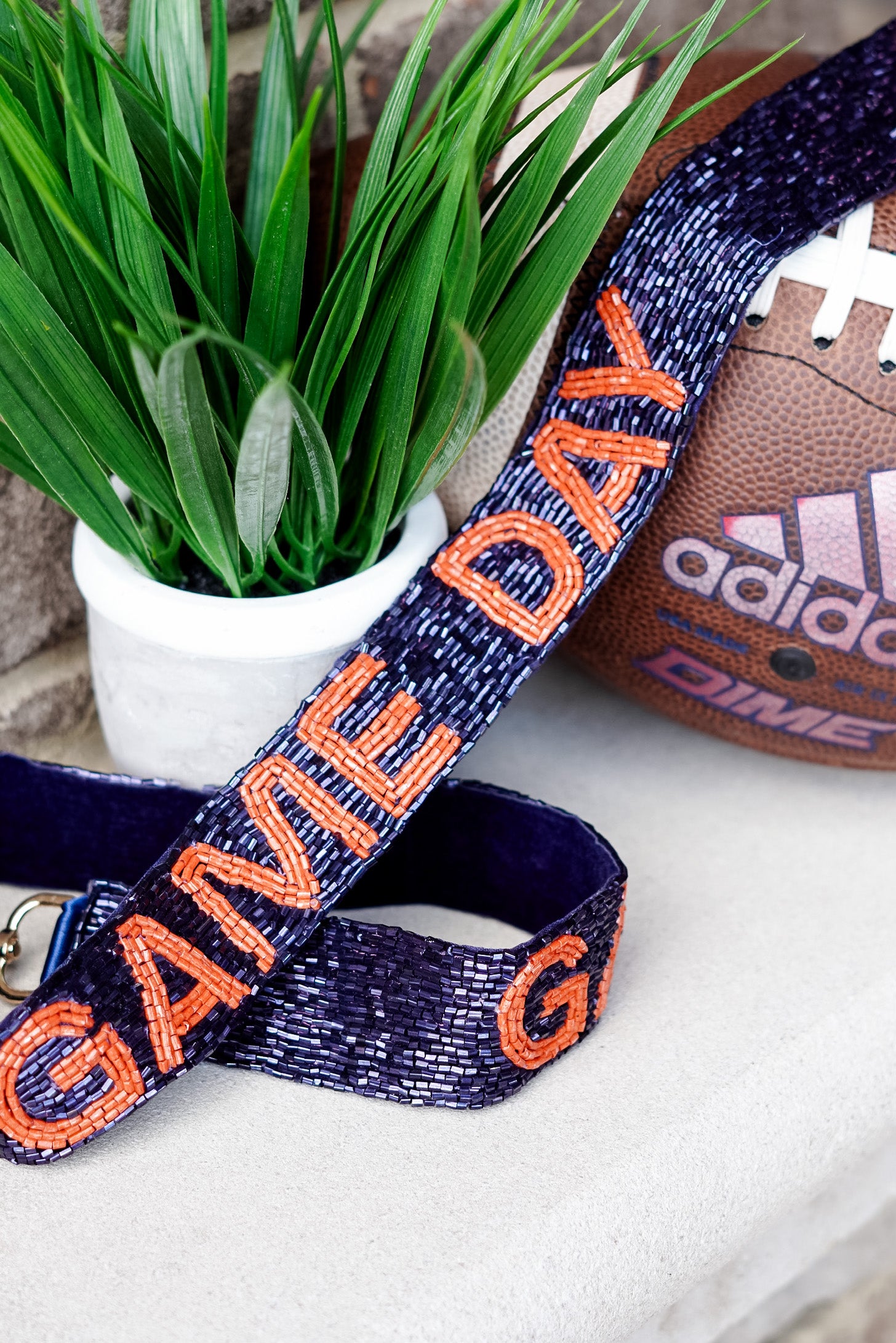 Blue beaded strap with orange lettering that says "Game Day"