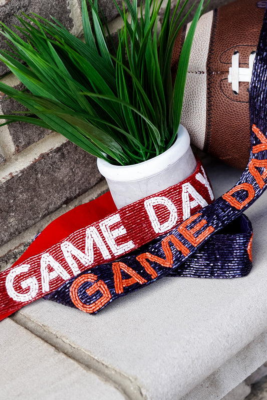 Clear bags can be such a bore when your outfit is on point for game day!! No fear, grab a Game Day Beaded Crossbody Strap whether you are Rolling with the Tide or headed to the Plains!!  Game Day Beaded Crossbody Straps 46-48" long 1.5" Wide Gold Clips. Game day beaded straps, in navy and orange for Auburn fans and crimson and white for Alabama fans.