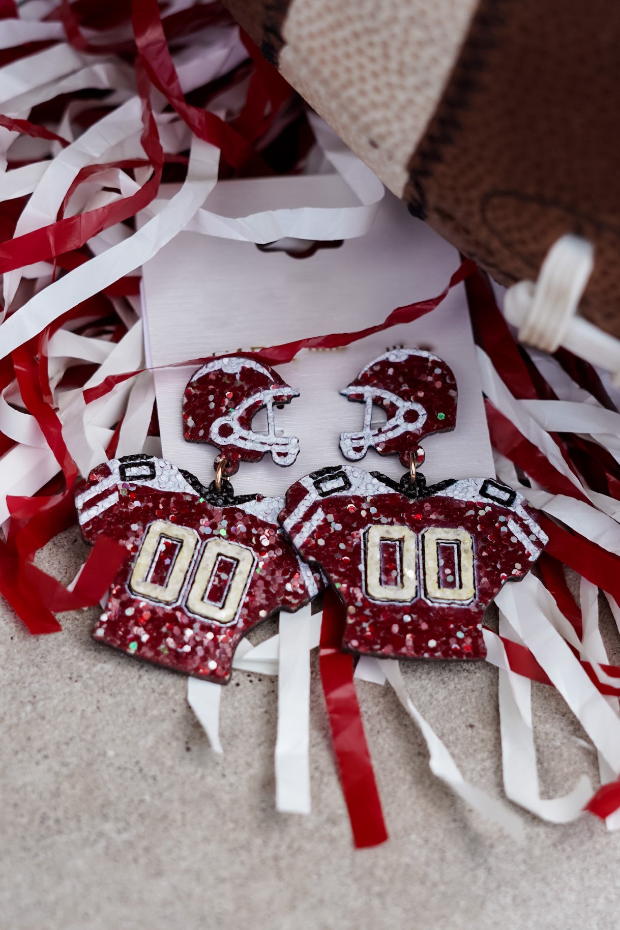 Red/white sequin jersey with crimson football helmet on the post.