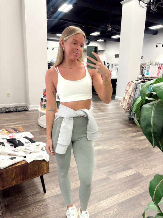 powder color sport bra, scoop neckline, dig-free straps.