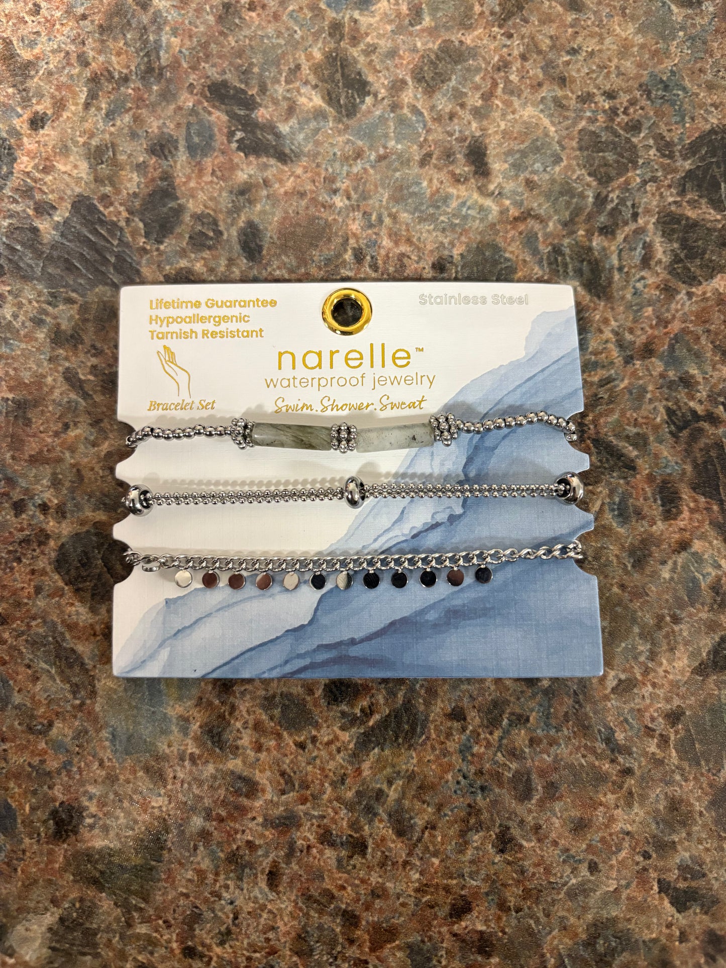 Narelle bracelet set on a branded card with silver chains with gray and silver charms and beads
