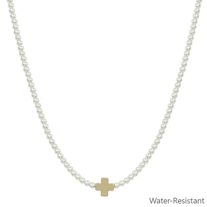 beaded pearl necklace with a gold cross pendent