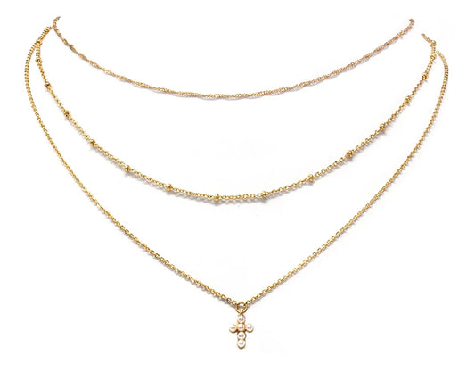 gold three layered necklace, a small beaded chain, a small pearl cross pendent in one of the necklaces.
