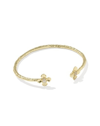 Gold Texture bracelet with a clover charm that has a pearl in the center on a white background.