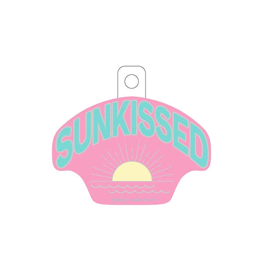 pink sticker with "sunkissed" scripted in blue and a sunrise graphic below.