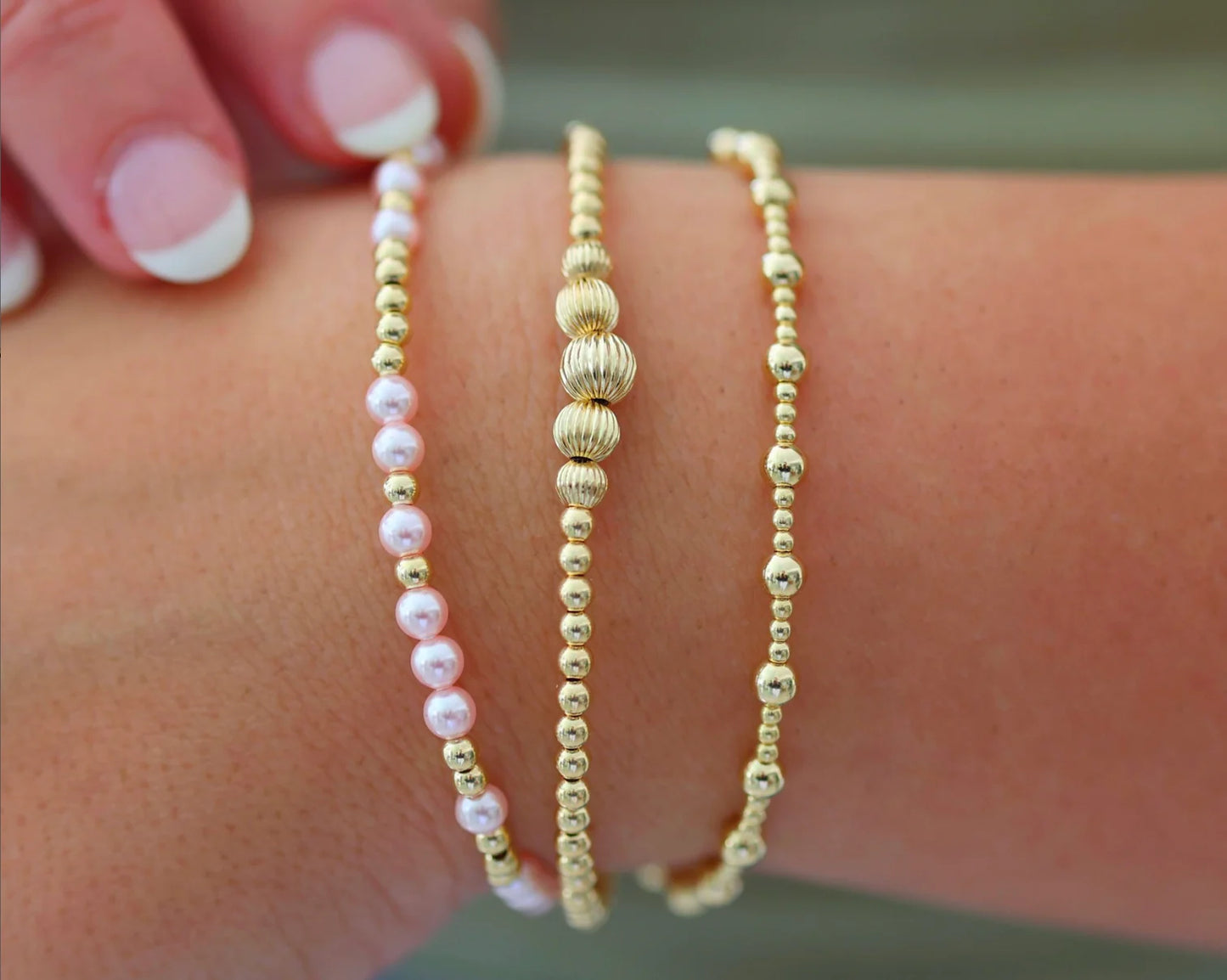 3 Piece Bracelet Set, All Gold, One with Pink and Gold Beads, One All Gold, and One 5 Larger Gold Beads