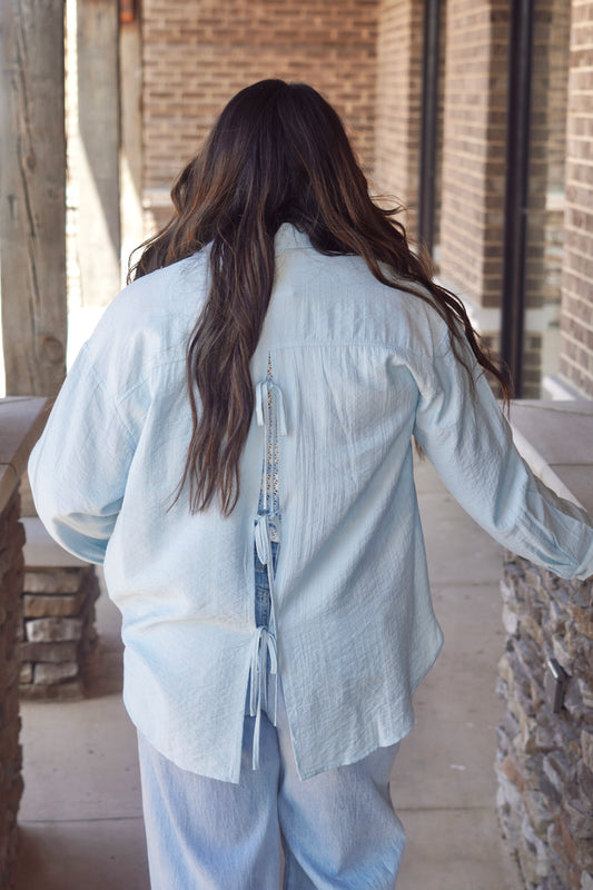 Blue button up with ties details in the back.
