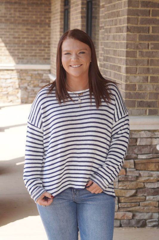 Women wearing a navy and blue Striped Knit Sweater, Round Neckline, Long Sleeves, Relaxed Fit, Full Length.