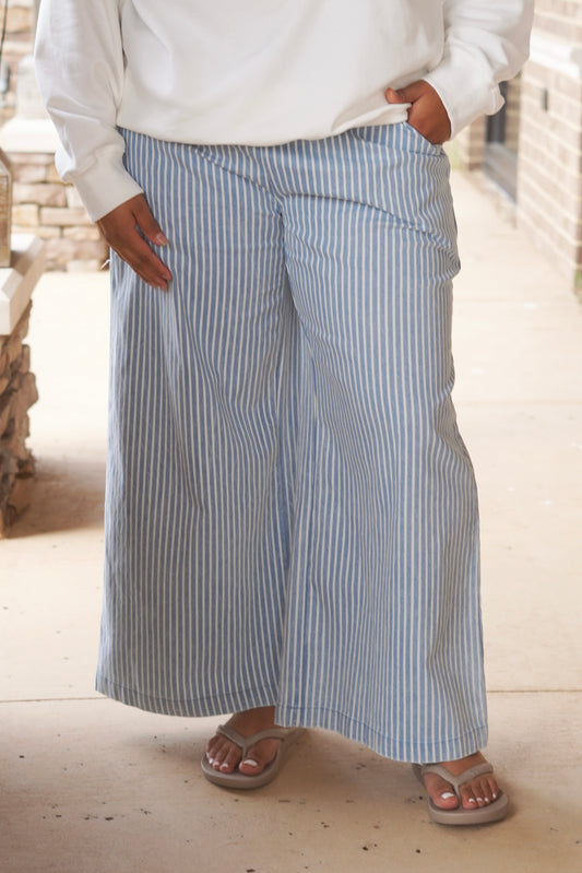Denim blue pants with white stripes and an elastic waist band.