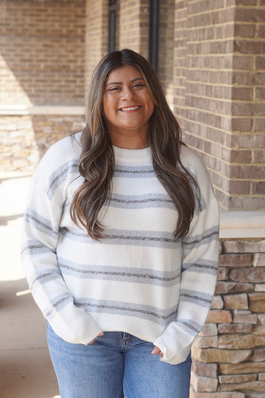 Women wearing a blue and grey Striped ivory Knit Sweater, Round Neckline, Long Sleeves, Relaxed Fit, Full Length.
