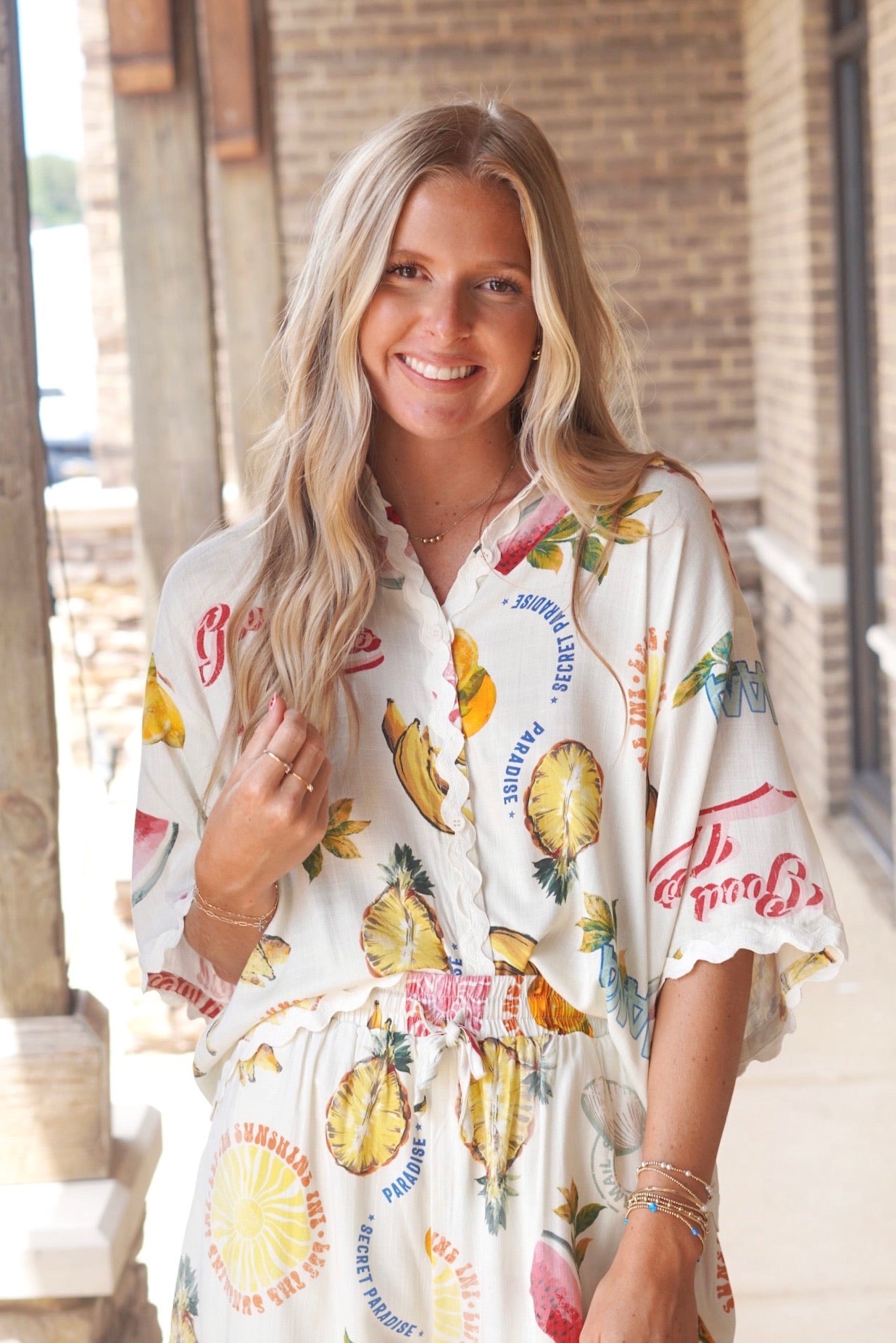 Cream colored button up top, wavy trim, tropical paradise print, cropped, collared