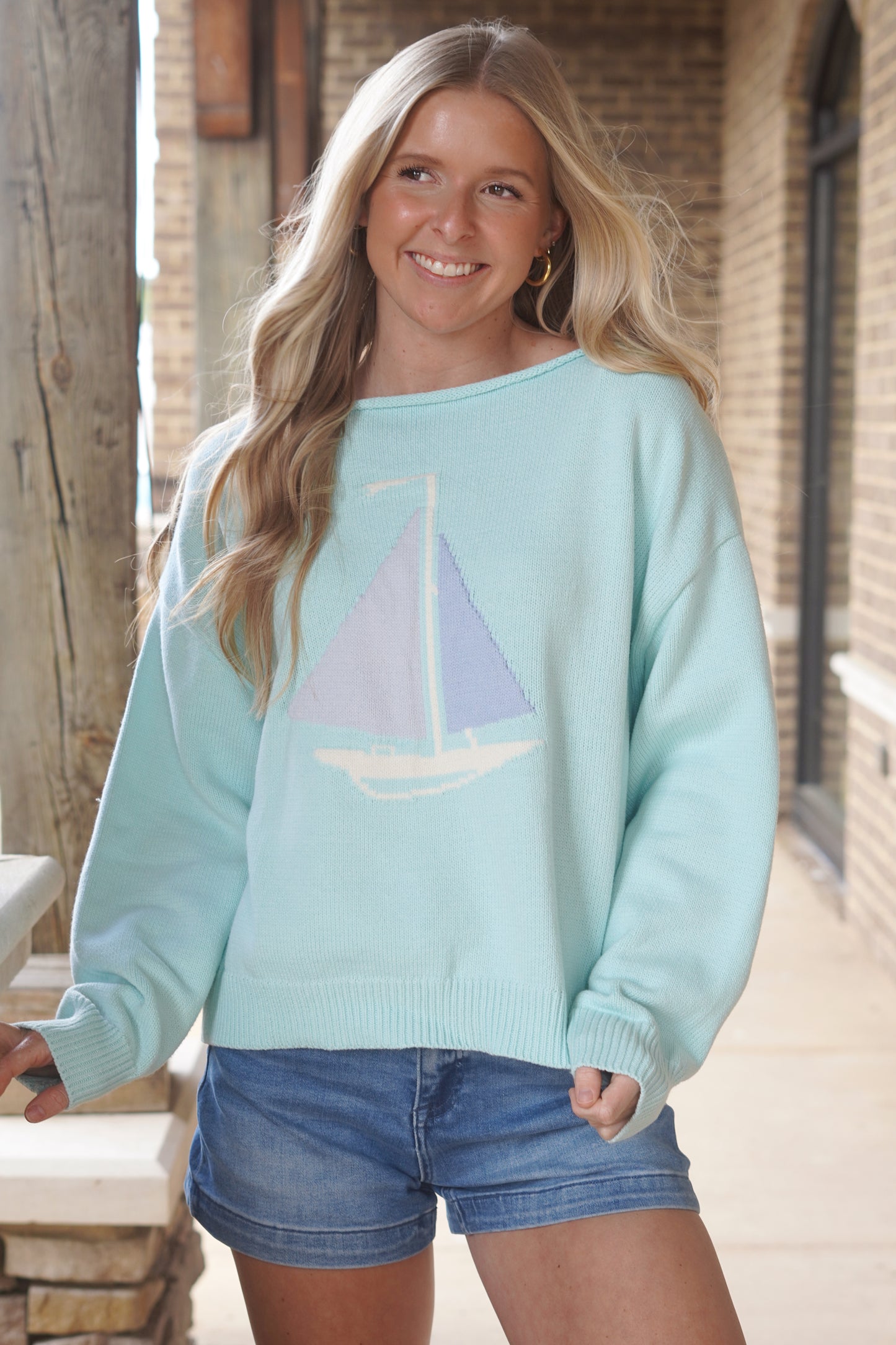 Women wearing a Mint Sweater, with a Baby Blue Sail boat, Boat neckline