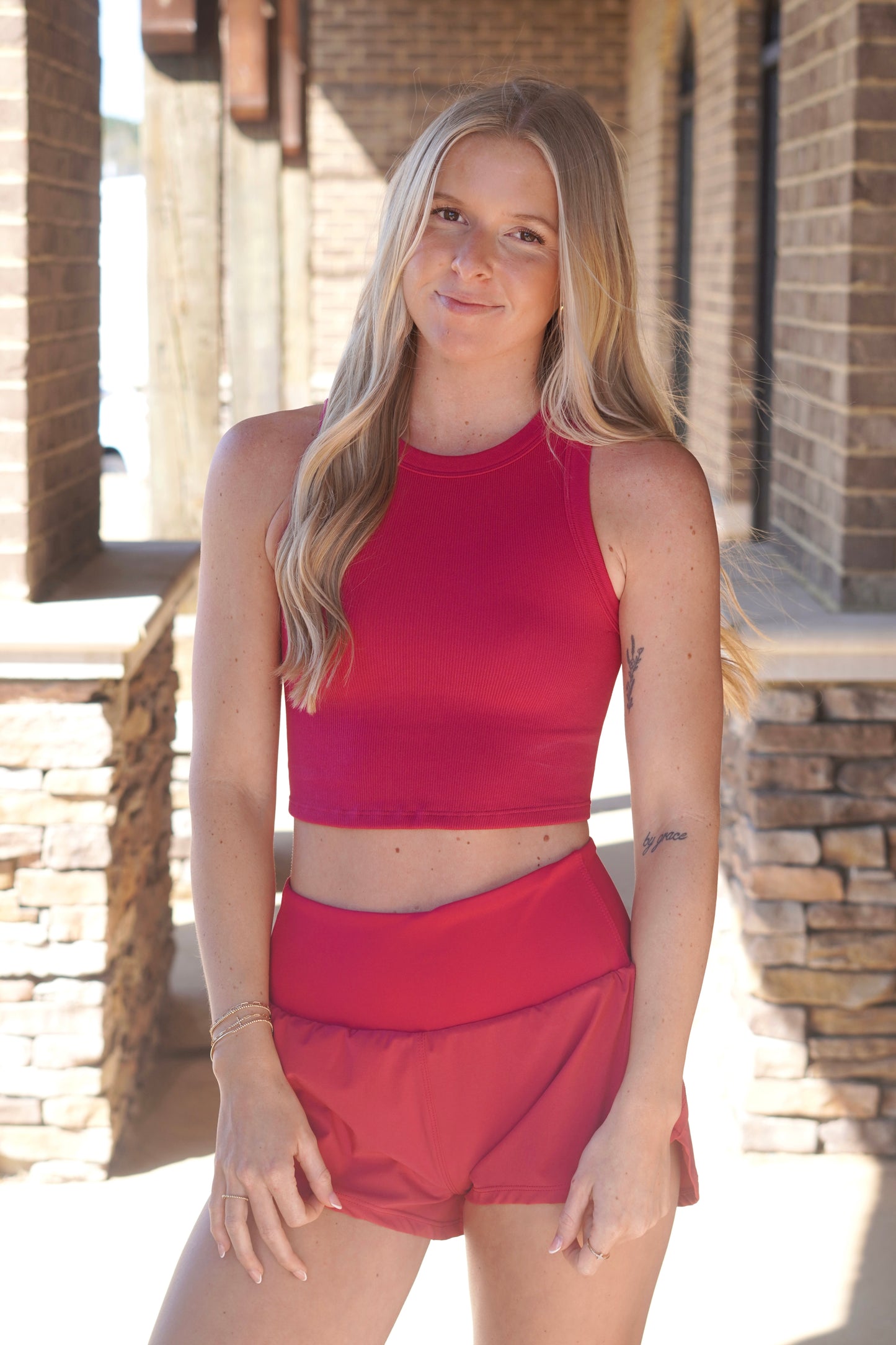 Women Wearing a pink mid-length tank, crewneck line, paired with pink shorts