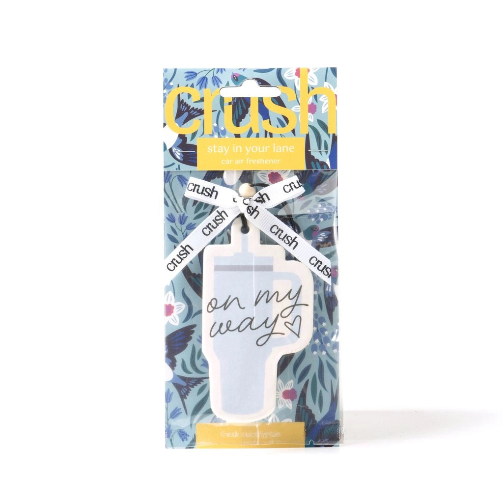Car freshener in the scent fresh eucalyptus in the shape of a tumbler that says "on my way"