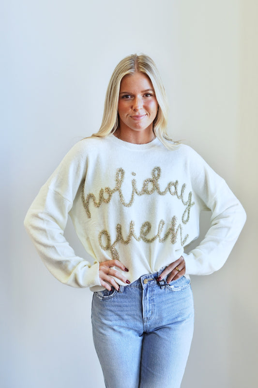 Holiday Queen Tensile Scripted Sweater Crew Neckline Long Cuffed Sleeves Full Length "Holiday Queen" In Scripted Lettering w/ Gold Tensile Color: Cream Relaxed Fit 52% Acrylic, 30% Nylon, 15% Polyester, 3% Spandex