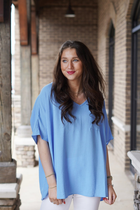 Feel Free V-Neck Lightweight Top V-Neckline Short Sleeves Light weight Front Pocket Color: Sky Blue Relaxed Fit Full Length 100% Polyester