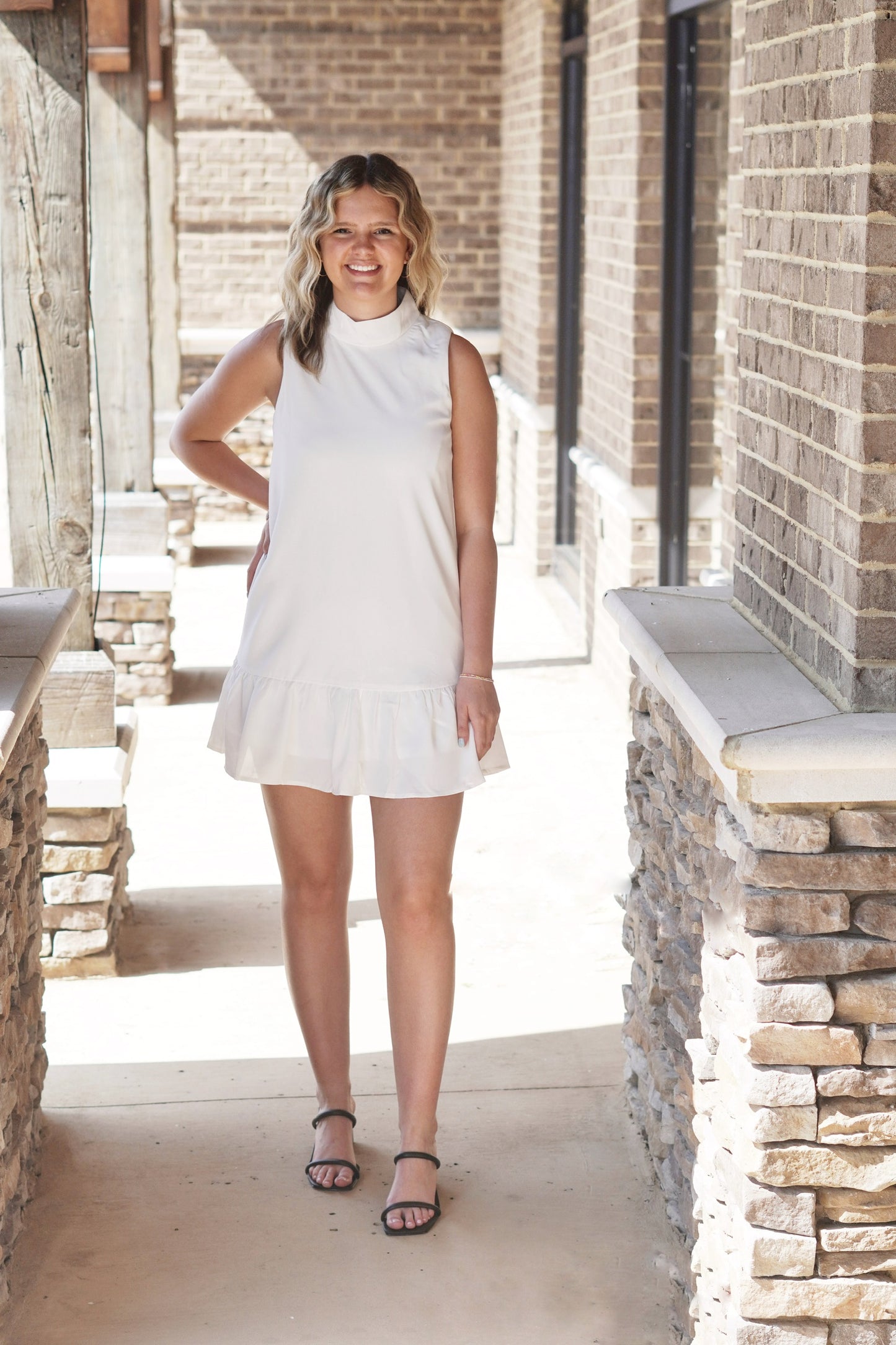 Malta Mock Neck Ruffle Hem Dress Mock Neckline Sleeveless Ruffle Hem Color: White Dress Slip Underneath Relaxed Fit Knee Length 100% Polyester