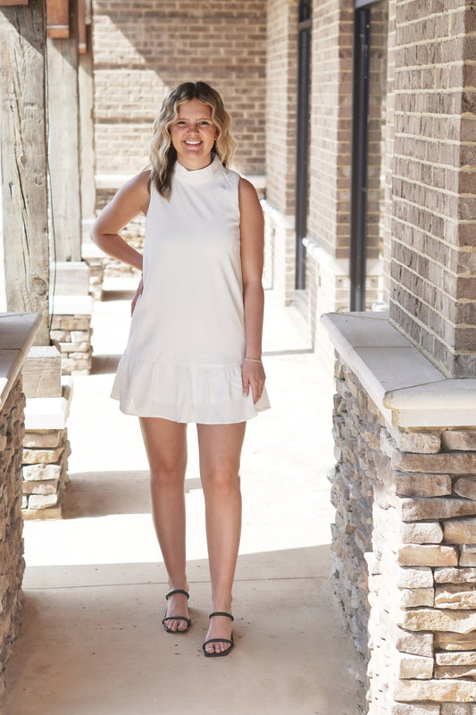 Malta Mock Neck Ruffle Hem Dress Mock Neckline Sleeveless Ruffle Hem Color: White Dress Slip Underneath Relaxed Fit Knee Length 100% Polyester