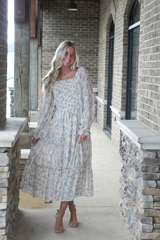 Charlotte Floral Midi Dress Smoked Neckline Long Sleeve Floral Print Color: Cream Multi Flowy Fit Dress Underlining Midi Length Fabric Content: 100% Polyester