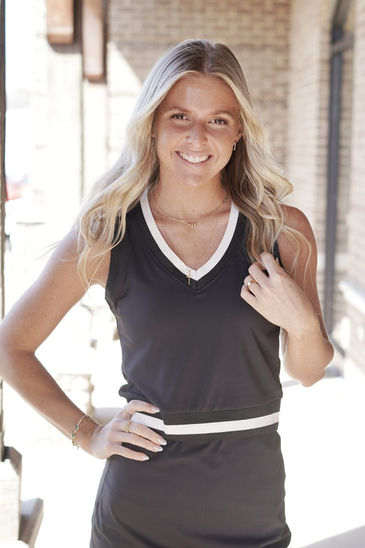 <ul> <li>Stay Active V Neck Tennis Top</li> <li>V Neck Line</li> <li>Sleeveless</li> <li>Pink/White Stripe Trim</li> <li>Full Length</li> <li>Built In Bra Pads</li> <li>Colors: Black/White, </li> <li>True To Size</li> <li>Fitted</li> <li>85% Recycled Nylon, 15% Spandex</li> </ul>