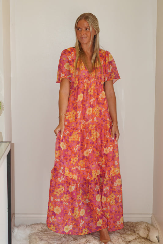            Summer is coming up and this Farryn Flutter Sleeve Maxi Dress is the perfect addition to your closet. On a warm sunny day heading to church or a day out with your friends, this dress with its perfect vibrant colors will have you looking fabulous!  Floral Pattern 100%Polyester,100% Polyester Lining Open Back Tie Detail