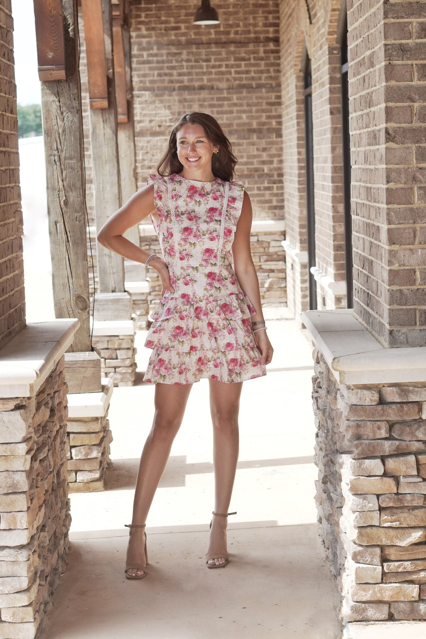 Dozen Roses Ruffle Tiered Dress Sleeveless Ruffle Lined Bodice Color: Pink Mix w/ Rose Design Tiered Ruffle Feature Mid-Thigh Length Fitted Underlining 100% Cotton