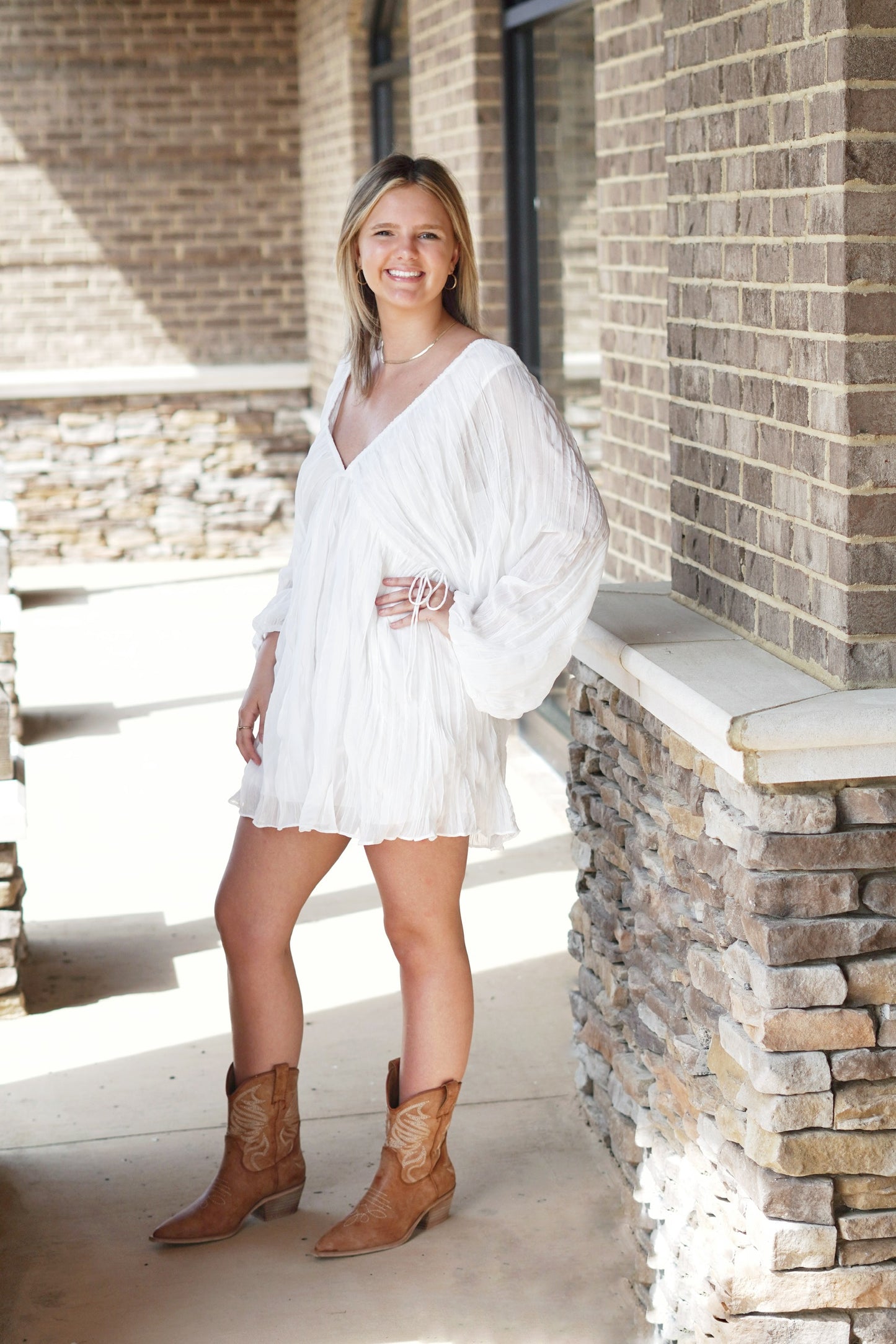 <ul> <li>Willow V-Neck White Flowy Dress</li> <li>V-Neckline</li> <li>Long, Puff Sleeves</li> <li>V-Neckline With String Tie Closure</li> <li>Mid-Thigh Length</li> <li>Flowy Fit</li> <li>Dress Underlining</li> <li>Color: White</li> <li>True To size</li> <li>Fabric Content: 100% Polyester Lining, 98% Polyester, 2% Spandex</li> </ul>