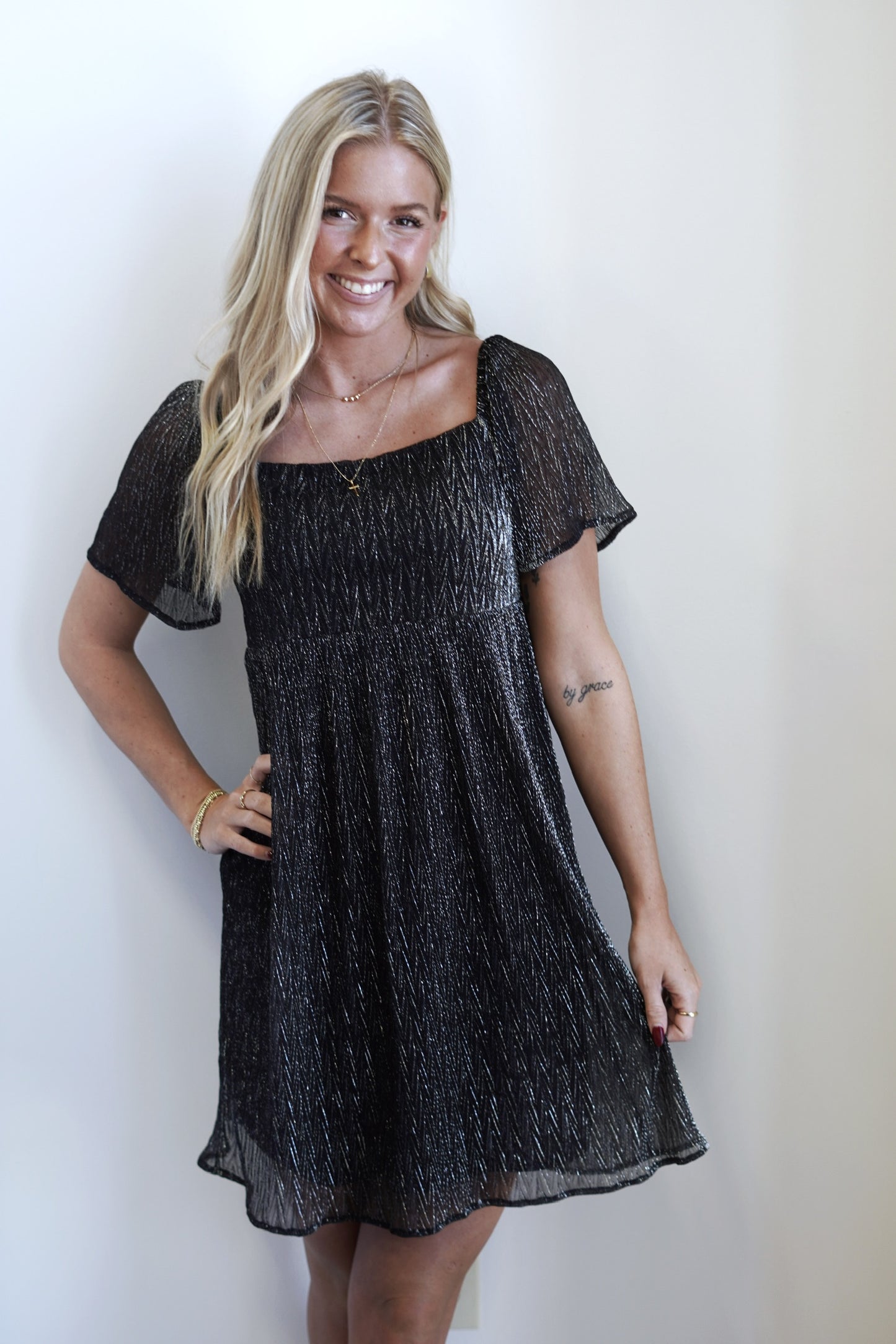 Sabrina Square Neck Textured Shimmery Dress Square Neckline Short Sleeves Knee Length Lurex Material w/ Chiffon Detailing Colors: Black and Silver A-Line Fit 55% Polyester, 45% Metallic