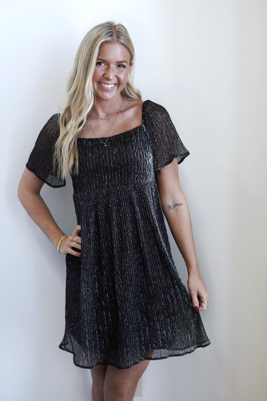 Sabrina Square Neck Textured Shimmery Dress Square Neckline Short Sleeves Knee Length Lurex Material w/ Chiffon Detailing Colors: Black and Silver A-Line Fit 55% Polyester, 45% Metallic