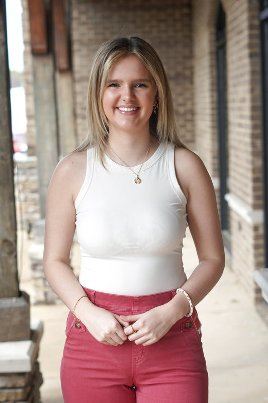 <ul> <li>Spanx Suit Yourself Racer Ribbed Bodysuit</li> <li>Fitted to the body</li> <li>Rounded Neckline</li> <li>Soft ribbed fabric</li> <li>Sleeveless</li> <li>racerback</li> <li>Core-smoothing design</li> <li>Colors: Parchment, </li> <li>Bodysuit</li> <li>Fabric Content: <span data-mce-fragment="1">66% Polyester, 34% Elastane. Gusset: 100% Cotton</span></li> </ul>