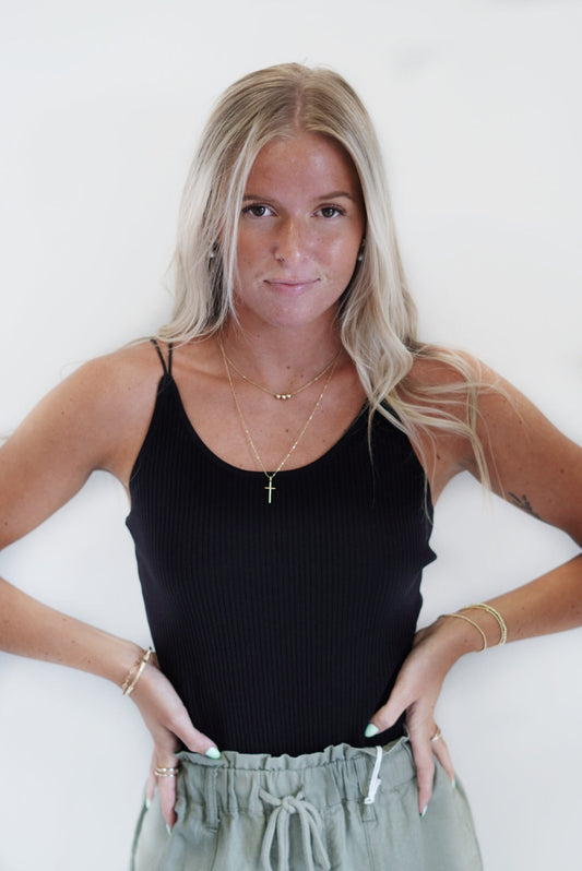 Shealy Open Back Ribbed Bodysuit Round Neckline Spaghetti Strap Low Back, Criss-Cross Detail Black, Cream Fitted 100% Nylon Hand Wash Cold, Do Not Bleach, Line Dry, Iron Low Model is wearing size small