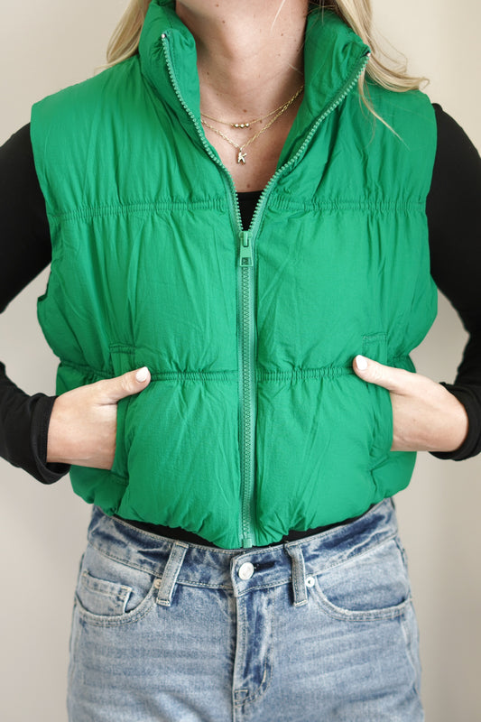 The Essential Cropped Puffer Vest Collar Neckline Sleeveless Pockets Color: Green Cropped Length 100% Nylon