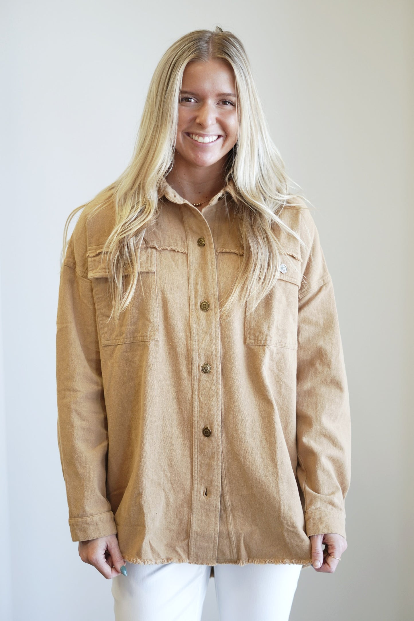 All You Need is Love Shacket Collared Neckline Long Cuffed Sleeves "All You Need is Love" in white lettering graphic on the back Color: Camel Oversized Length and Fit 100% Cotton