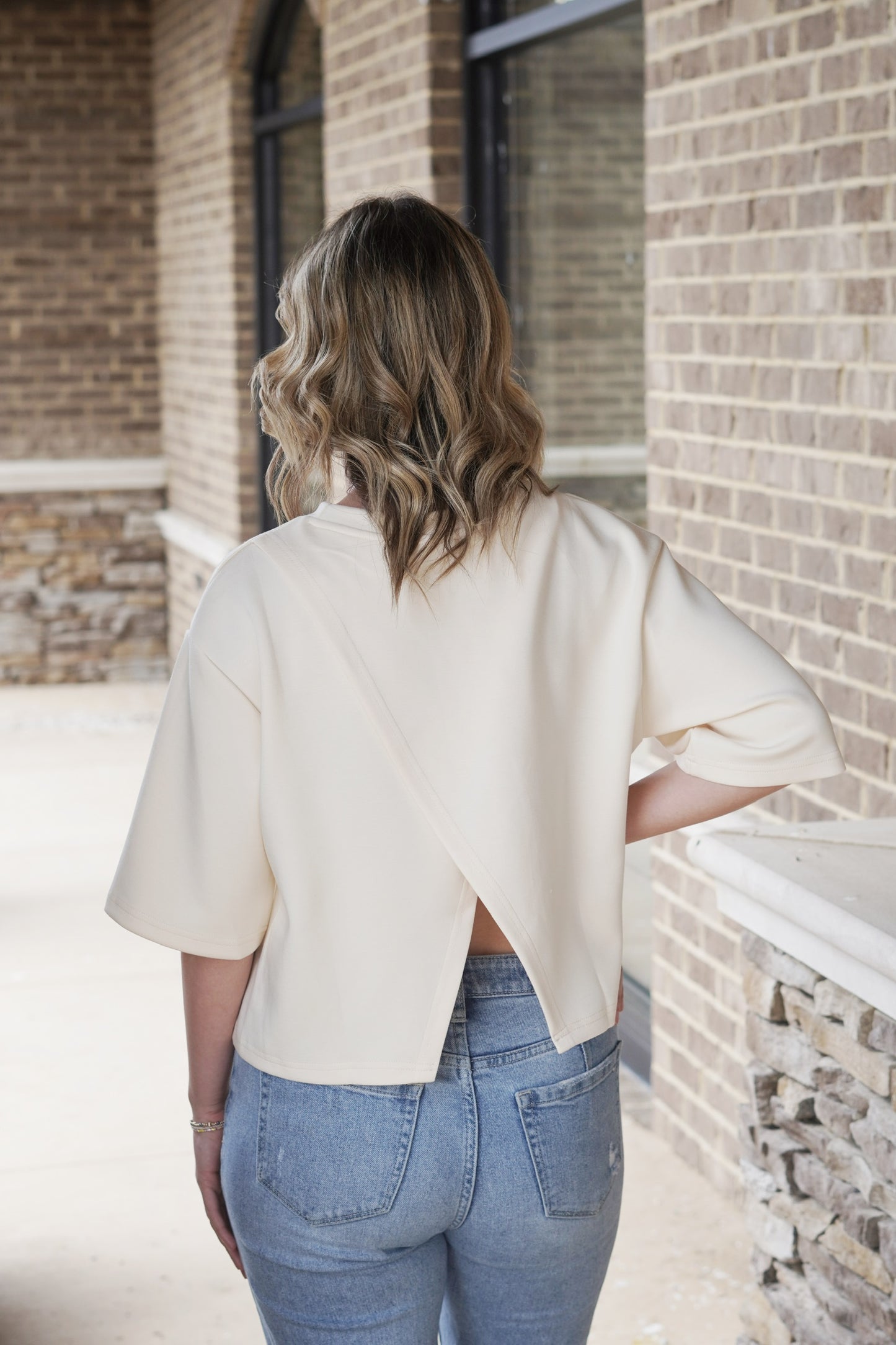 Lina Layered Split Back Modal Top Crew Neckline Short Sleeves Layered Split Back Feature Color: Eggshell Skimmer Length' Relaxed Fit 48% Modal, 48% Polyester, 4% Spandex