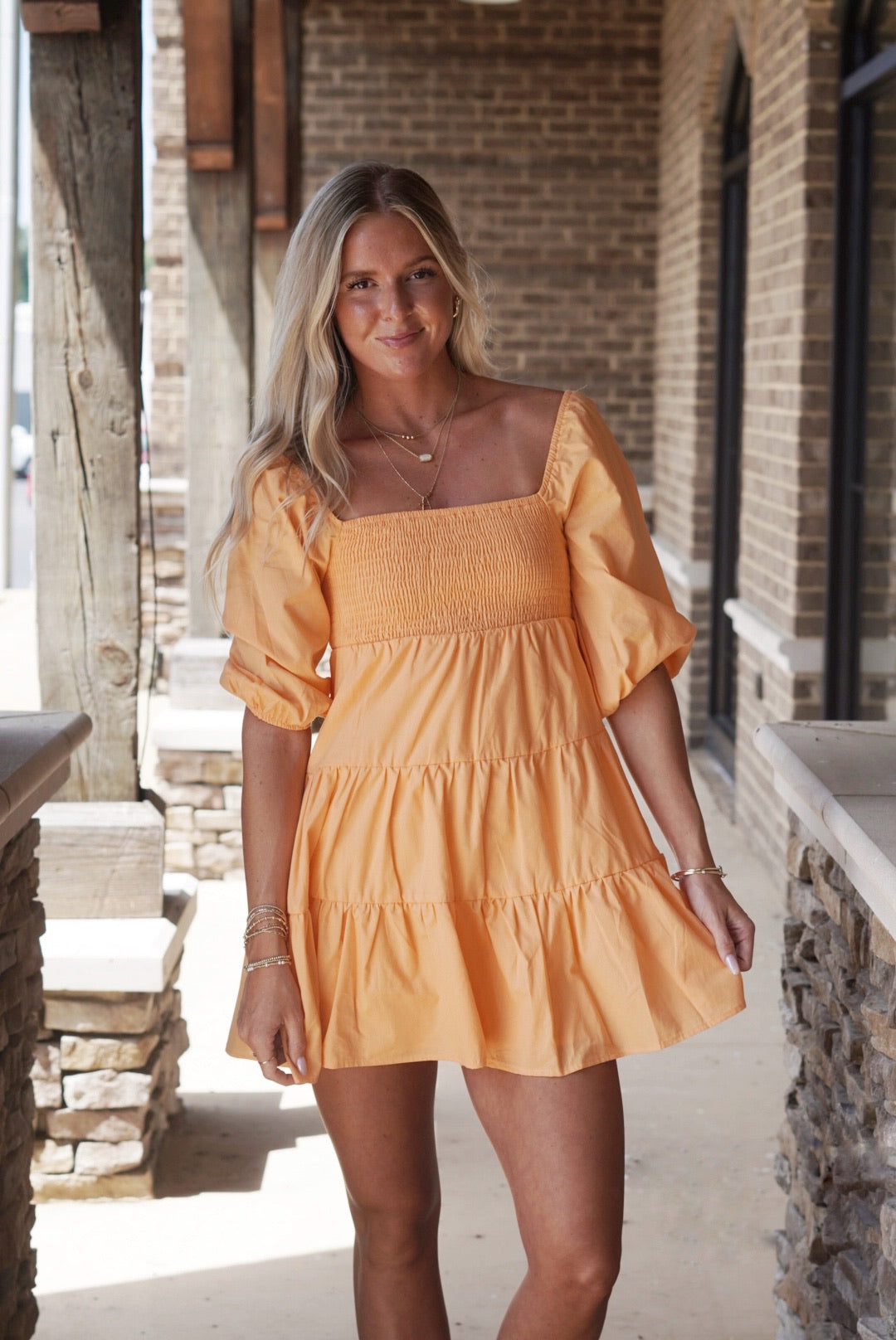 Sunshine Smocked Puff Sleeve Mini Dress Square Neckline Short Puff Sleeves Tiered Style Color Options: Orange Mid-Thigh Length A-Line Fit 100% Cotton