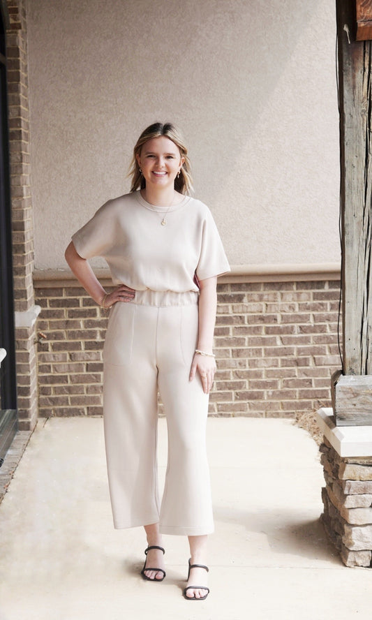<ul> <li>Spanx Airessentials Cropped Wide-leg Jumpsuit</li> <li>Round Neckline</li> <li>Short Sleeves</li> <li>Button Closure On Back Of Neckline</li> <li>Color: Tahini</li> <li>Airessentials Material</li> <li>Cropped Wide Leg Pants</li> <li>Side Pockets On Pants</li> <li>Cinch Waist</li> <li>Fit: True To Size</li> <li>Fabric Content: <span data-mce-fragment="1">47% Modal, 46% Polyester, 7% Elastane. Pockets: 80% Polyester, 20% Elastane.</span></li> </ul>