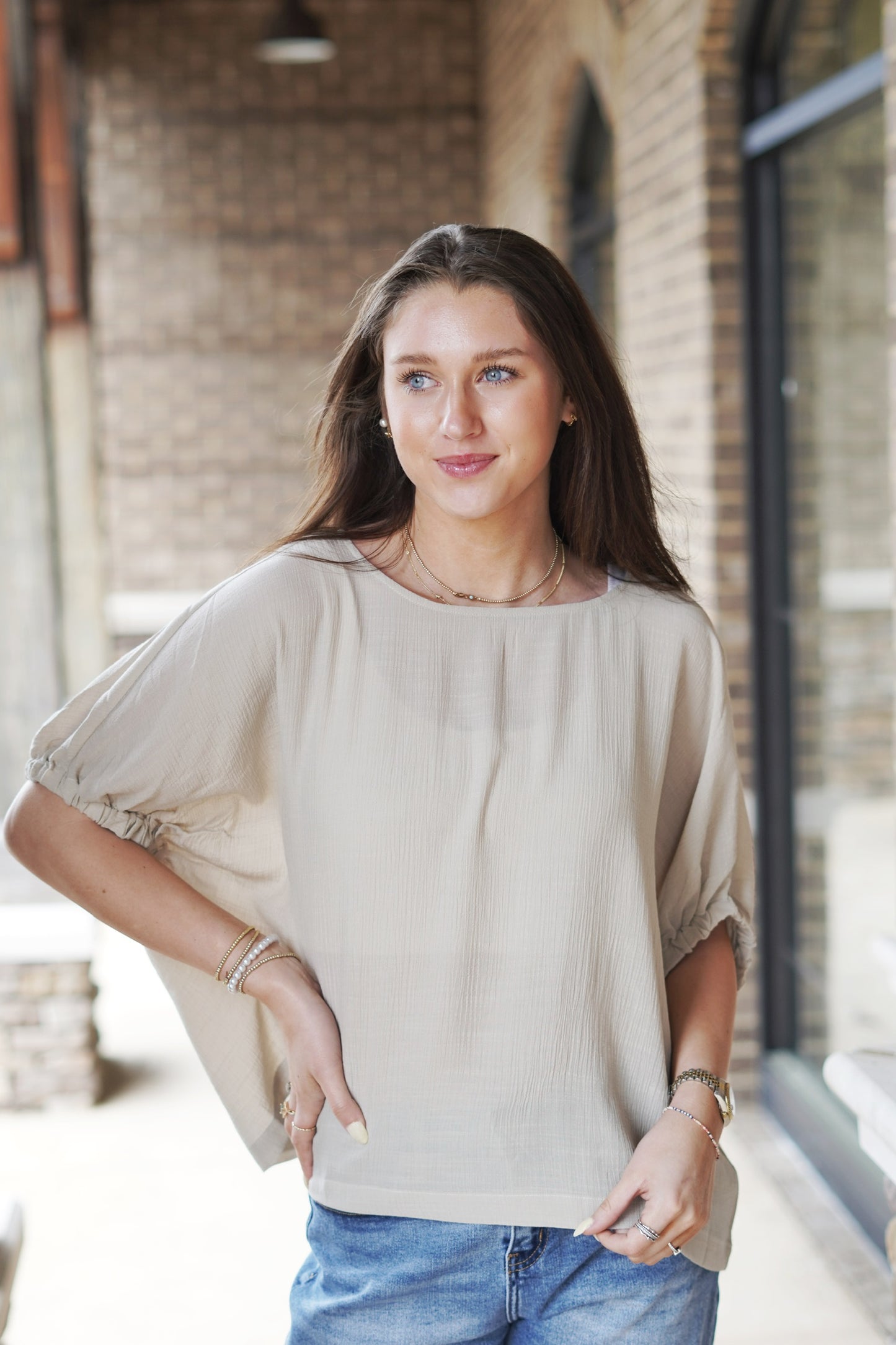<ul> <li>Emmie Elastic Sleeve Blouse Top</li> <li>Round Neckline</li> <li>Short Elastic Sleeves</li> <li>Light Weight Material</li> <li>Color: Oatmeal</li> <li>Full Length</li> <li>Relaxed Fit</li> <li>65% rayon, 35% polyester</li> </ul>